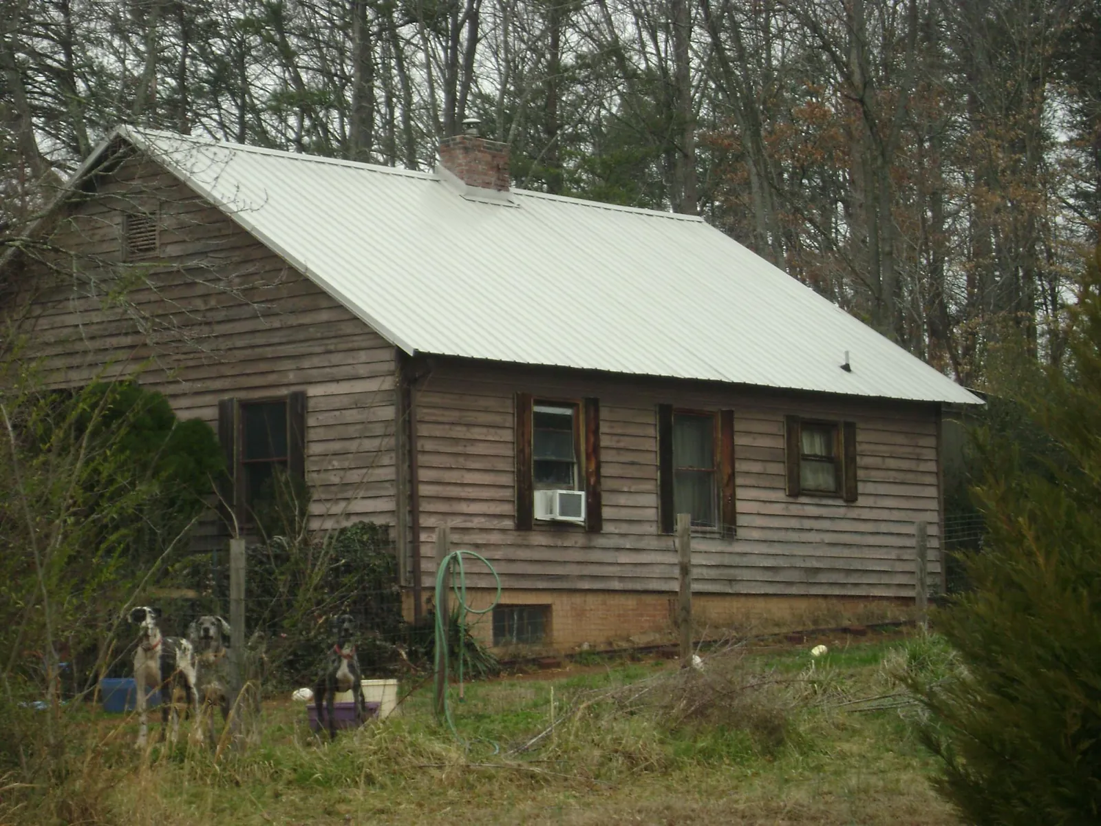 White metal roof on an old wood sided farmhouse, from a Metal Roof Installation job in Babson Park